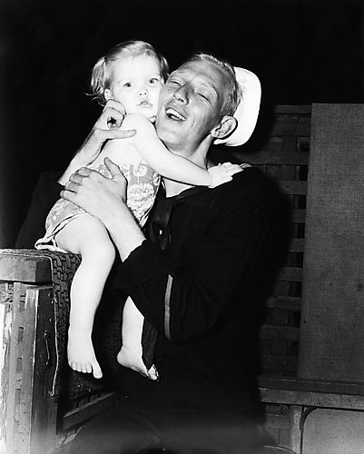 Sailor Embraces Little Girl