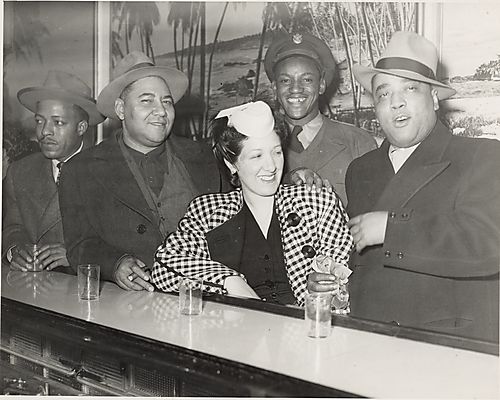 Emmanuel Jew" McPherson, his wife, and three men at the bar in Crawford Grill No. 2"