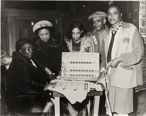 Practice poll: voting machine on table surrounded by five people, including two workers for the Rev. Talley campaign for Pittsburgh City Council