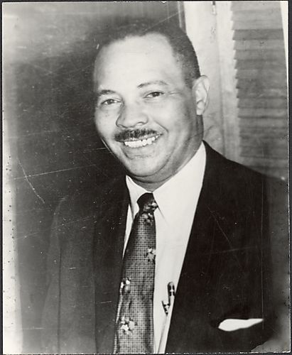 Man with floral tie and pencils in breast pocket