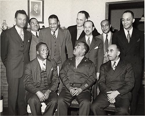 Group portrait including Dr. McKinley C. King and Charlie Cuthbert, Dr. Chester Harris in bottom row, with man at front center in military uniform