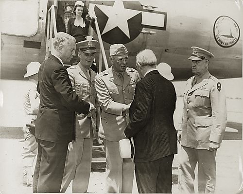 A civilian, possibly Mayor David L. Lawrence, greeting General Eisenhower beside an Air Force airplane