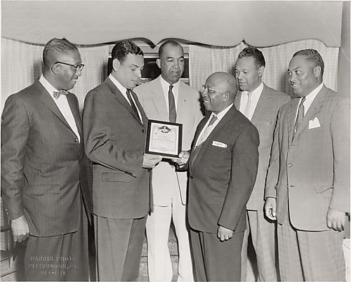 Attorney Henry Smith receiving an NAACP certificate from Dr. Chester Harris, Dr. Ralph Hadley, Dr. Charles Cephas, Dr. McKinley King and Dr. Max Johnson