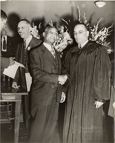 Judge Homer S. Brown shaking hands with his partner Paul Jones