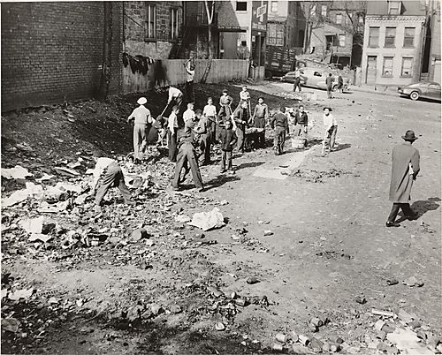 Courier staffer George Brown and children cleaning up empty lot on Pittsburgh's North Side