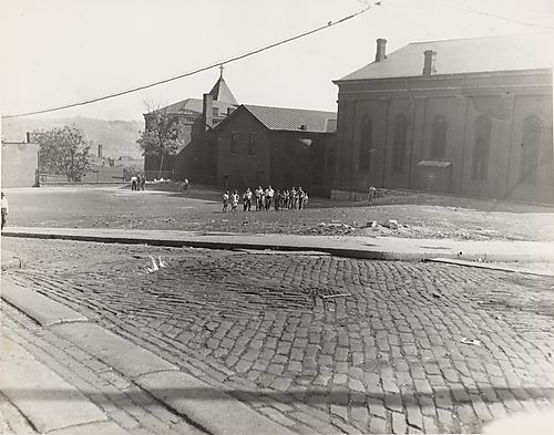Group of boys crossing churchyard