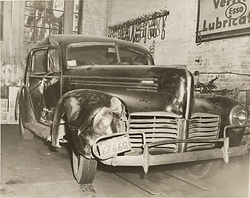 Hudson car with passenger side damage parked in Esso service station