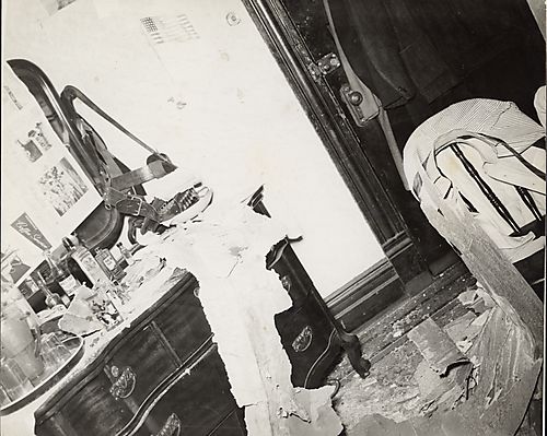 Dressing table with drinks and gun holster damaged by fallen plaster