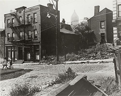 Apartment buildings and empty lot with the Gulf Building in the distance