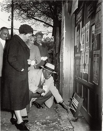 Mr. Young demonstrating voting machine to Florence Williams and another woman, possibly Teenie Harris' cousin