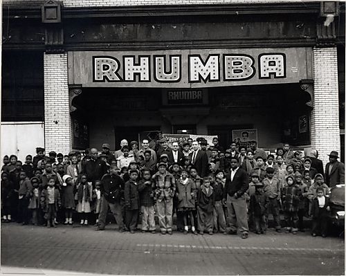 Children and the theatre owners in front of the Rhumba Theatre on Fullerton Street