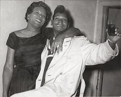 Woman embracing man with cigarette and drink