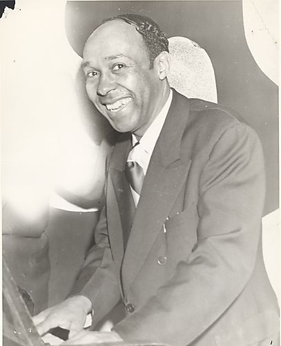 Churchill Kohlman, composer and entertainer, playing the piano