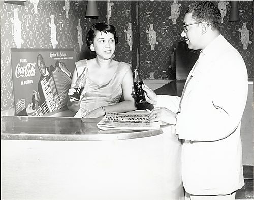 Man and woman drinking Coca Cola at bar