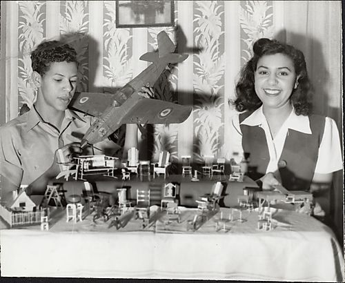 Betty Lowery and her brother with model planes and miniature furniture