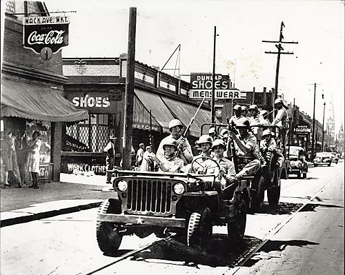 Soldiers in two jeeps on Mack Street, Detroit