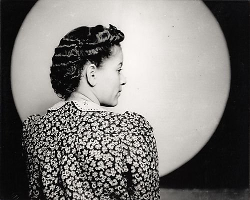 Portrait of Wynona Graves in profile, owner of the La Salle Beauty Salon on Centre Avenue, modeling a hair style, in Harris studio