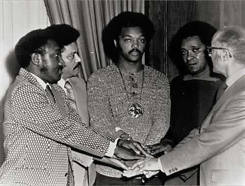 Larry Jackson or Anderson, Harvey Adams, Jesse Jackson, Clyde Jackson, and Robert Lavelle placing hands together