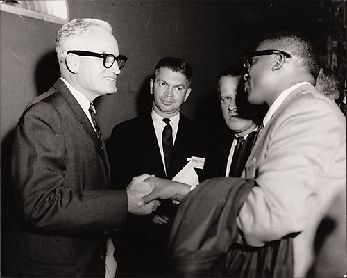 George Barbour, city editor of the Pittsburgh Courier, shaking hands with Senator Barry Goldwater