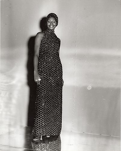 Model in an evening gown with matching headpiece