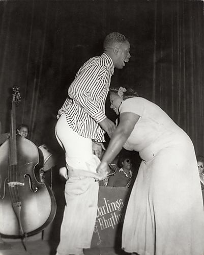 Comedy act Butterbeans &amp; Susie" performing with band "Darlings of Rhythm" in background"