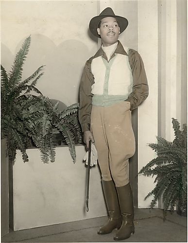 Fashion model Louie Smith wearing jodhpurs holding gloves and crop