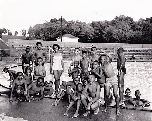Informal group portrait of swimmers at a pool