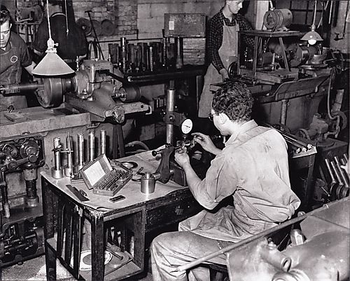 Four men working in metals shop