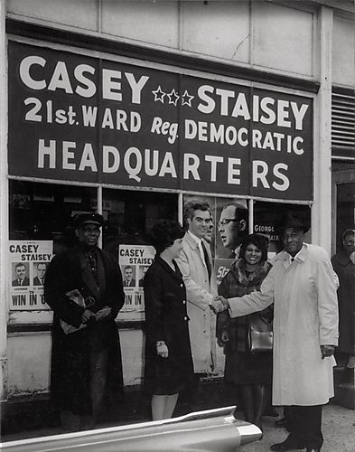 The candidate, his wife, and three supporters in front of Casey Staisey headquarters, 21st ward Democratic Party, in the Hill District