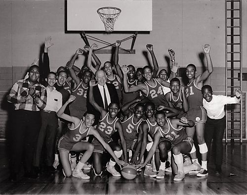 Schenley High School basketball team cheering, including trainer Joe Lee
