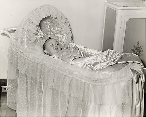 Baby in satin-lined bassinette