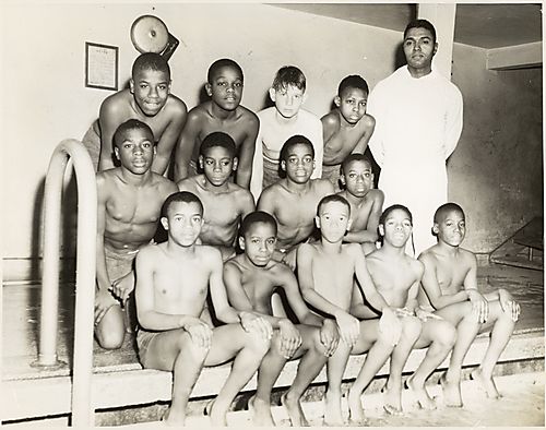 Boys' swim team with coach Pomeroyal Fountain at Centre Avenue YMCA, Hill District