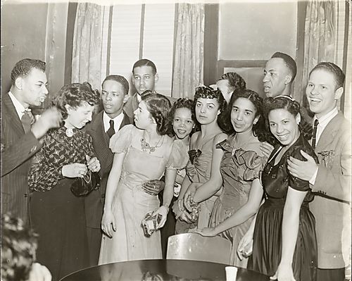 Six men and six women, possibly friends and employees of the Pittsburgh Courier, including Florine Robinson, in semi-formal dress