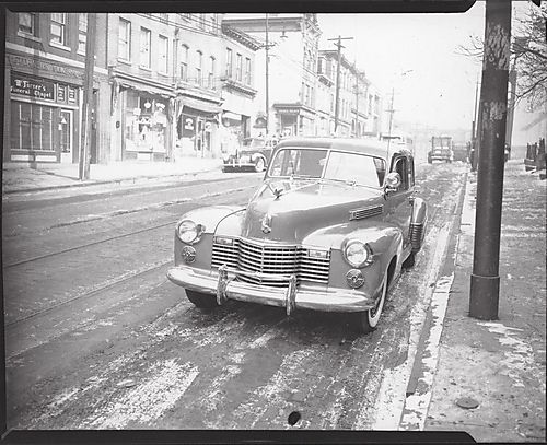 Cadillac car parked in street across from McTurner's Funeral Chapel