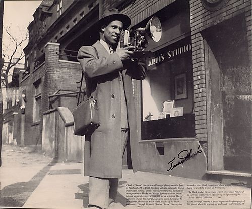 Charles Teenie" Harris with camera outside his studio"