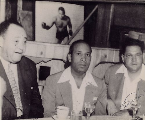 Numbers Guys: Gus Greenlee, Woogie Harris, and Joe Robinson, including photograph of John Henry Lewis in background