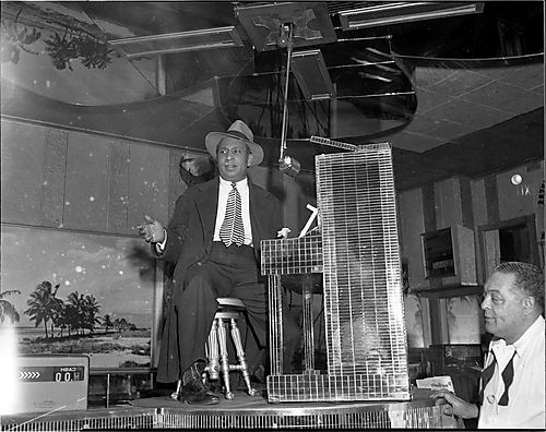 Woogie Harris seated at mirrored piano, with bartender Tom West on left, in Crawford Grill No. 2