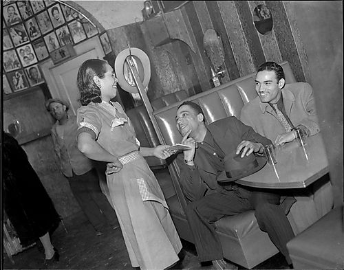 Waitress talking to two men in booth at Crawford Grill?