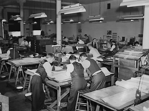 Engineers and Draftsmen Discussing a Drawing