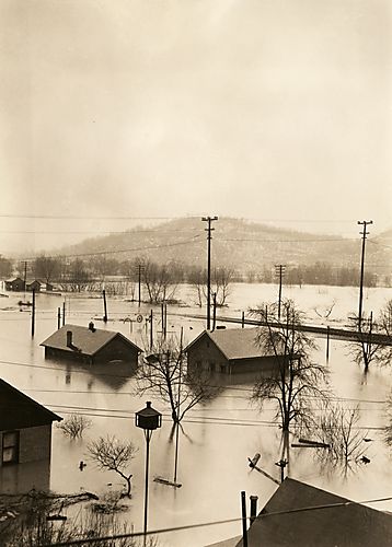 Flood Water and Debris Threaten Homes