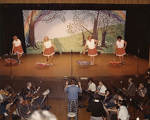 Men in Drag Dance with Umbrellas