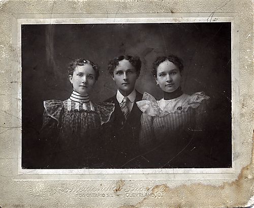 Portrait of a young man and two women