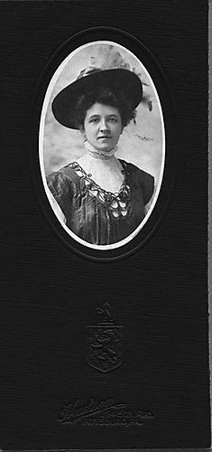 Portrait of a woman in black, wearing a hat