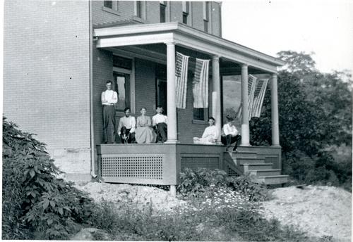 Denny Family on Front Porch with Flags