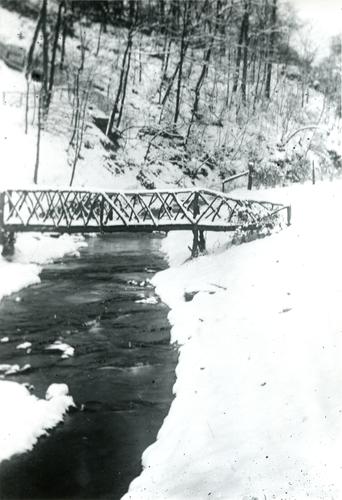 Snowy Bridge over Creek