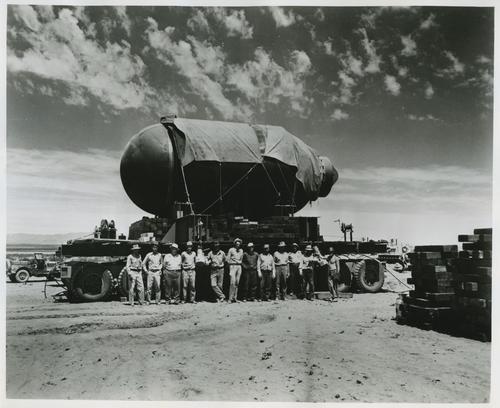 Workers posing with the atom bomb containment vessel