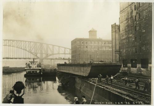Barge resting on train tracks after flood.
