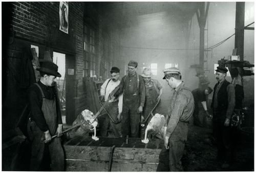 Workers pouring aluminum