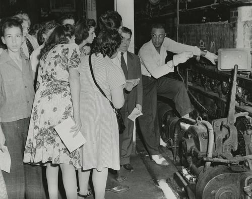 Employee explaining function of lehr during open house
