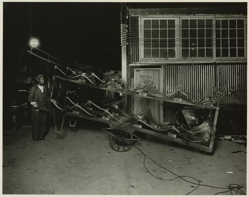 Employee transporting sheets of glass produced by compressed air process